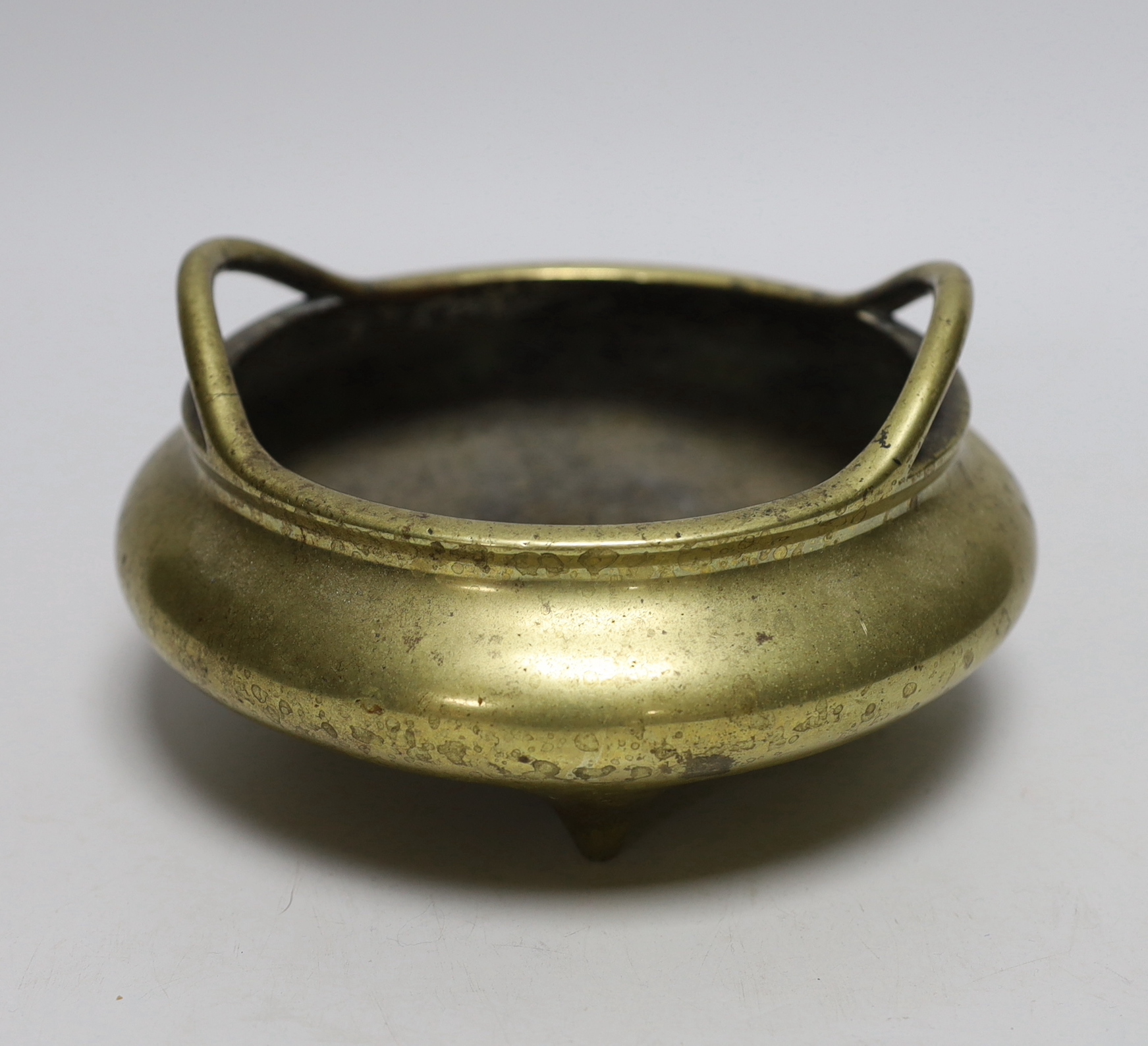 A late 19th century Chinese bronze censer with twin handles, apocryphal Xuande mark, 17.5cm in diameter